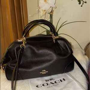 Beautiful Coach hand bag. Never been used and has original white coach sleeve.